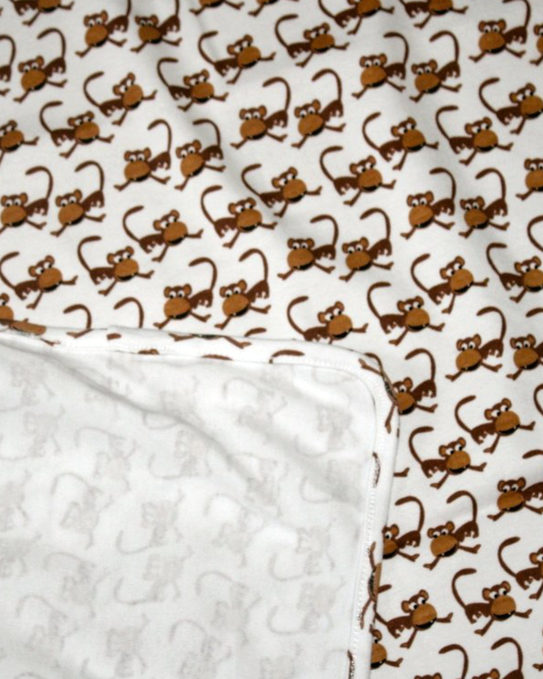 Babydecke in weiß mit braunen Äffchen